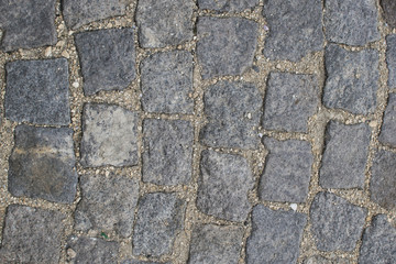 Obraz premium Part of road surface, paved with cobbles.