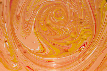 Photos of manufacturing a paint composite color. Mixing acrylic paint in different colors. Marbleized.