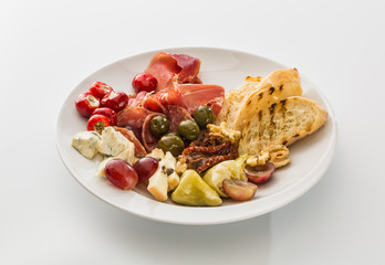 plate with peppers, bacon berries and cheese isolated on white background