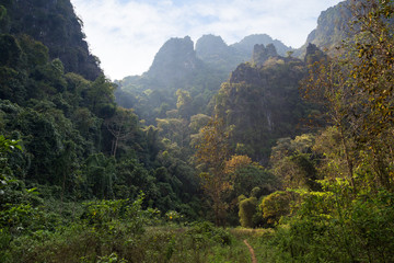 Scenic view of lush nature, limestone mountains and hills near Vang Vieng, Vientiane Province, Laos, on a sunny day.