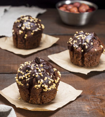 hocolate muffins on a brown wooden background