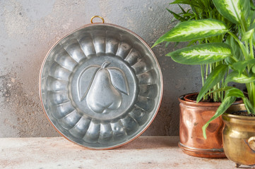 Vintage copper mold on a concrete background.