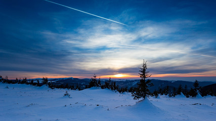 Astonishing sunset colours during a cold winter day in the mountains in Romania