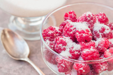 Glass of fresh raspberries sprinkled with white sugar gardening gastronomy harvest