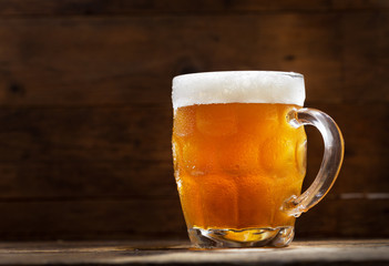 mug of beer on wooden table