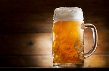 mug of beer on wooden table