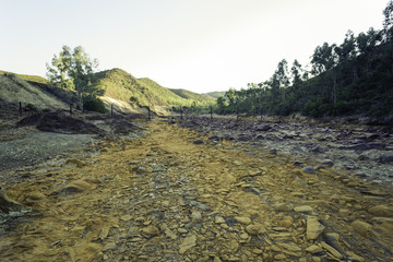 Dry riverbed with orange stones