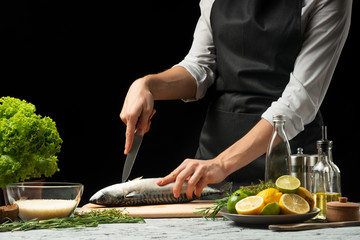 Chef salting mackerel fish 