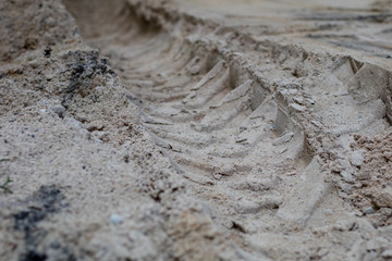 Wheel tracks from the car on the sand. Impressed tire tread.