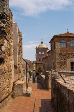 Walking on the wall of the medieval city of Caceres, Extremadura. Photo from Pulpitos Tower, the end of the way. Views of monuments in a sunny day.