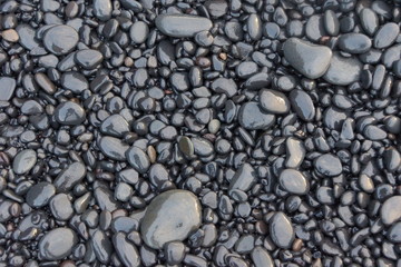 Fototapeta na wymiar Whet cobblestones at a beach on Iceland