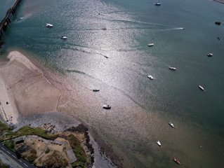 Aerial view, Drone panorama over sea, anchored yachts and beach over Mawddach river in Barmouth, Wales
