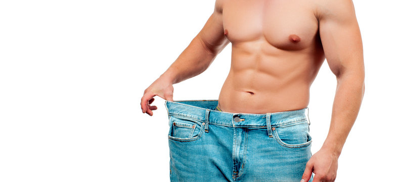 Man wearing big jeans after diet, weight loss