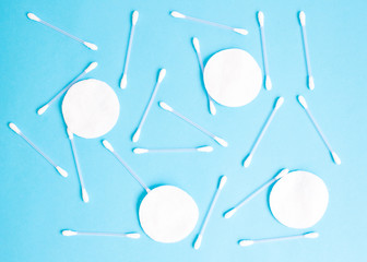 pattern of cotton buds and cotton pads on blue background