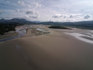 Aerial view, Drone panorama of Grifftan island on low tide sea in Snowdonia mountains in North Wales