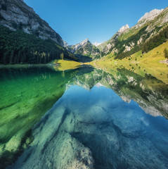 Mountains and lake in the Switzerland. Reflection on the water surface. Natural landscape in the Switzerland at the summer time. Lake and wave