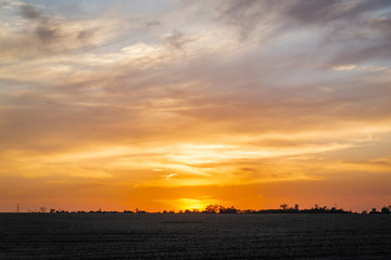 Golden sunset over rural landscape
