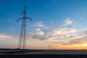 Fototapeta premium Rural landscape with high-voltage line on sunset