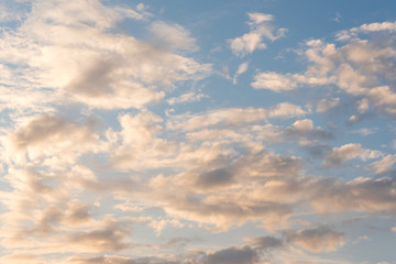 Beautiful cloudy blue evening sky with warm light- copy space