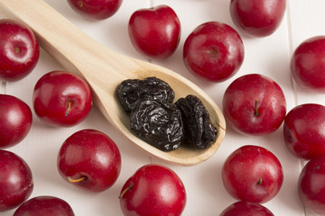 Fresh red plums and dehydrated plums
