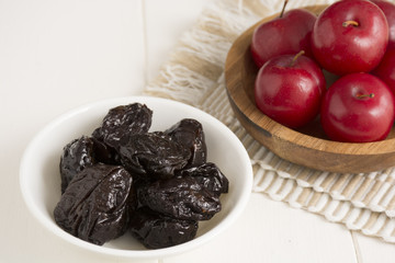 Fresh red plums and dehydrated plums
