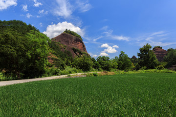 Wanfoshan Danxia Landform, Mount Wanfo. General Stone Scenic Area. Tongdao Dong Nationality Autonomous County, Hunan Province China. UNESCO World Heritage Location, Exotic Red Danxia, Green Grass