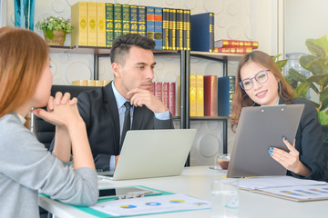 Financial report analysis and reviewing concept :CFO or chief financial officer sees financial summary reports with his secretary team and discusses about future growth and improvements