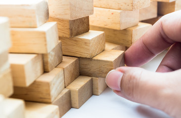 Wooden Blocks Wall, Selective focus  and hand hold on white background