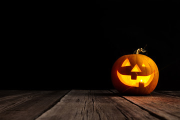 Cute Halloween pumpkin head jack lantern on wooden background