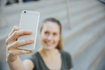 Woman in her twenties taking a selfie or videocalling