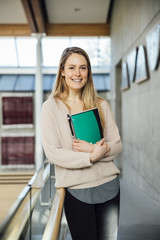 Caucasian Female University or College Student in Her Twenties Holding a Notebook