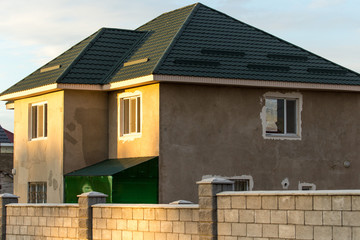 unfinished house and a roof against the blue sky.