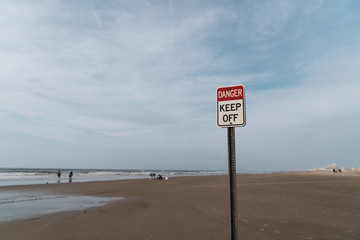 Danger Keep off Sign with Blue Cloudy Sky and New Jersey Beach in the Background