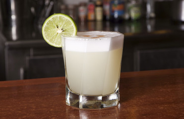 Peruvian cocktail called Pisco Sour made of Pisco Peruvian grape schnaps , lime juice, syrup, egg white, and some angostura bitter drops on top