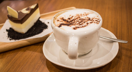 hot cappuccino with chocolate cake background
