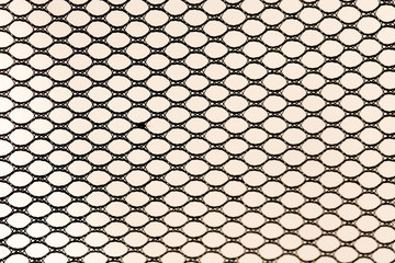 background, black synthetic fabric with holes