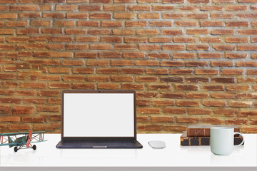 Loft workspace with mockup laptop on desk