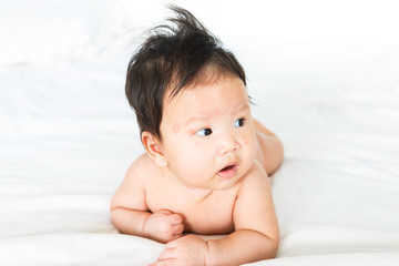 Asian baby girl with red spots on skin face