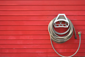 background of garden hose reel mounted on the wall