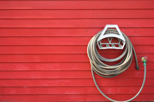 background of garden hose reel mounted on the wall