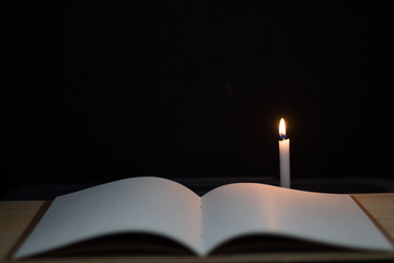 book open near lighting candles.