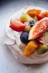 Meringue topping with fresh fruits including strawberry, mango, kiwi, blueberry and common fig served with sour fruit sauce.