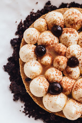 Creative dessert: Thin cream biscuit topping with cream, cocoa powder and chocolate crumble.  