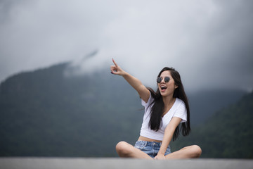 portrait of young beautiful girl woman happy with nature, against background of mountain and forest, nature scene