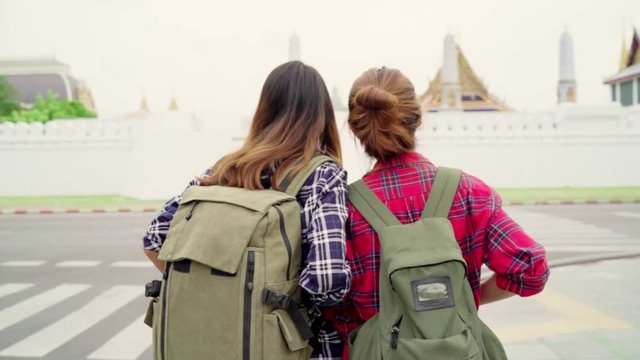 Slow motion - Traveler backpacker Asian women lesbian lgbt couple travel in Bangkok, Thailand. Happy young female spending holiday trip at amazing landmark and enjoy her journey in traditional city.
