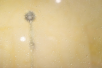Blur water drops on the glass in the shower bathroom with neon lights. for copy space background.