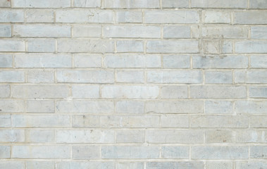 Old and dirty white brick wall for background texture.