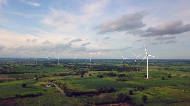 Aerial view of Windmills for electric power production at Huai Bong, Dan Khun Thot district, Nakhon Ratchasima. Large wind turbines were surrounded by corn field, Potato field and sugarcane field
