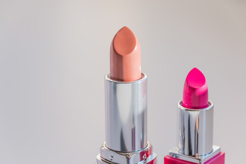 Assortment of lipsticks on white background.Lipsticks isolated on a white background and arranged to form a make up themed page footer.copy space