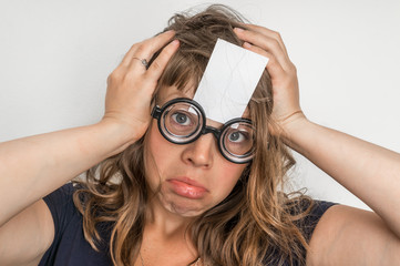 Funny woman with blank white sticky paper over her forehead